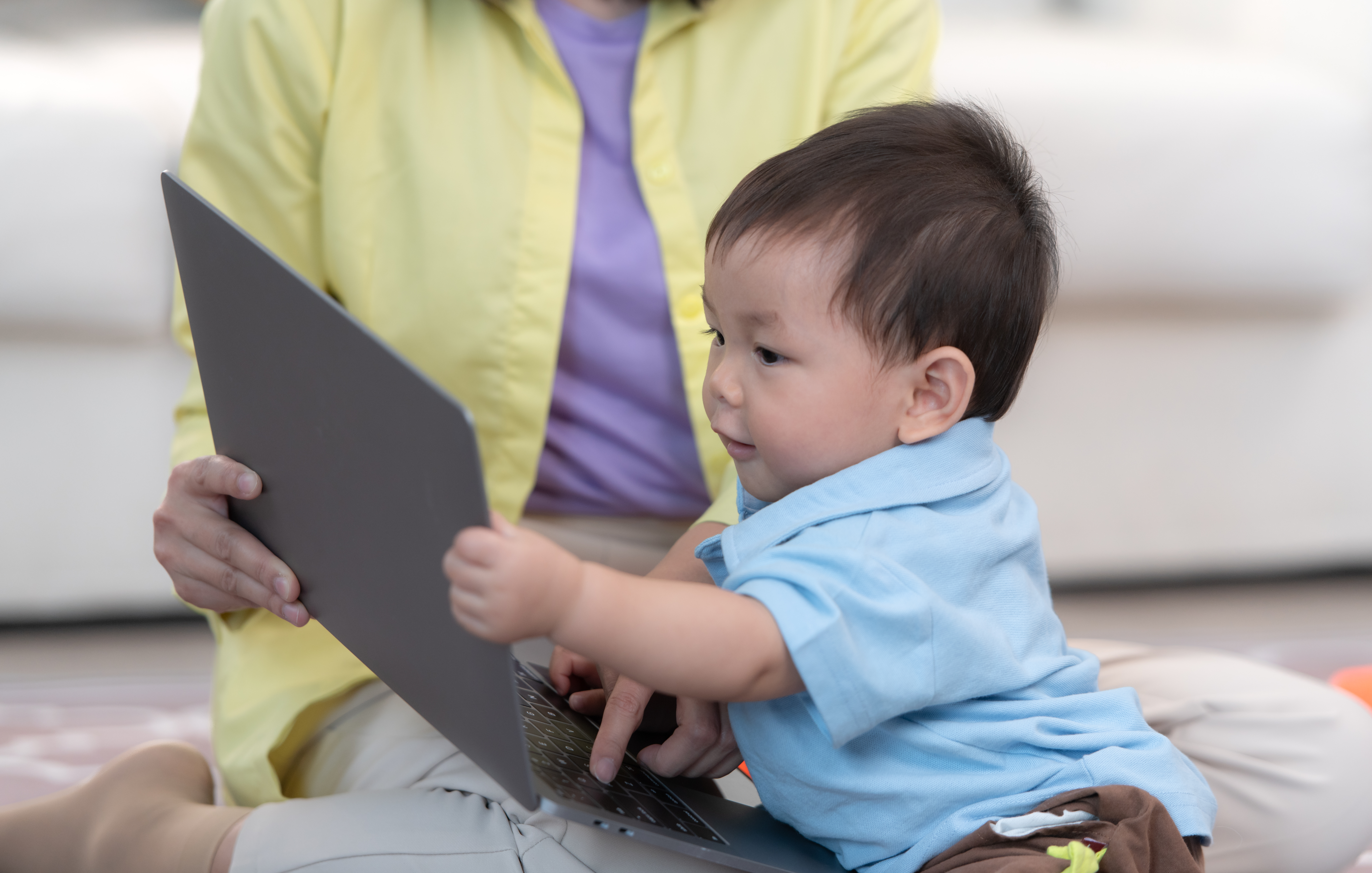 Mother and son play together after dad comes home from work